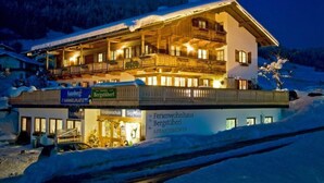 A multi-story hotel with balconies, a ski school, and a restaurant. - "DEPENDANCE BERGSTÜBERL" 102 (Reit im Winkl)