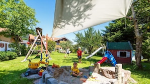 A playground with a slide, climbing structures, and sand play area. - 10 Apartment type D 71 sqm, balcony, 2 bedrooms, living room, max 4 p, WLAN (Ruhpolding)