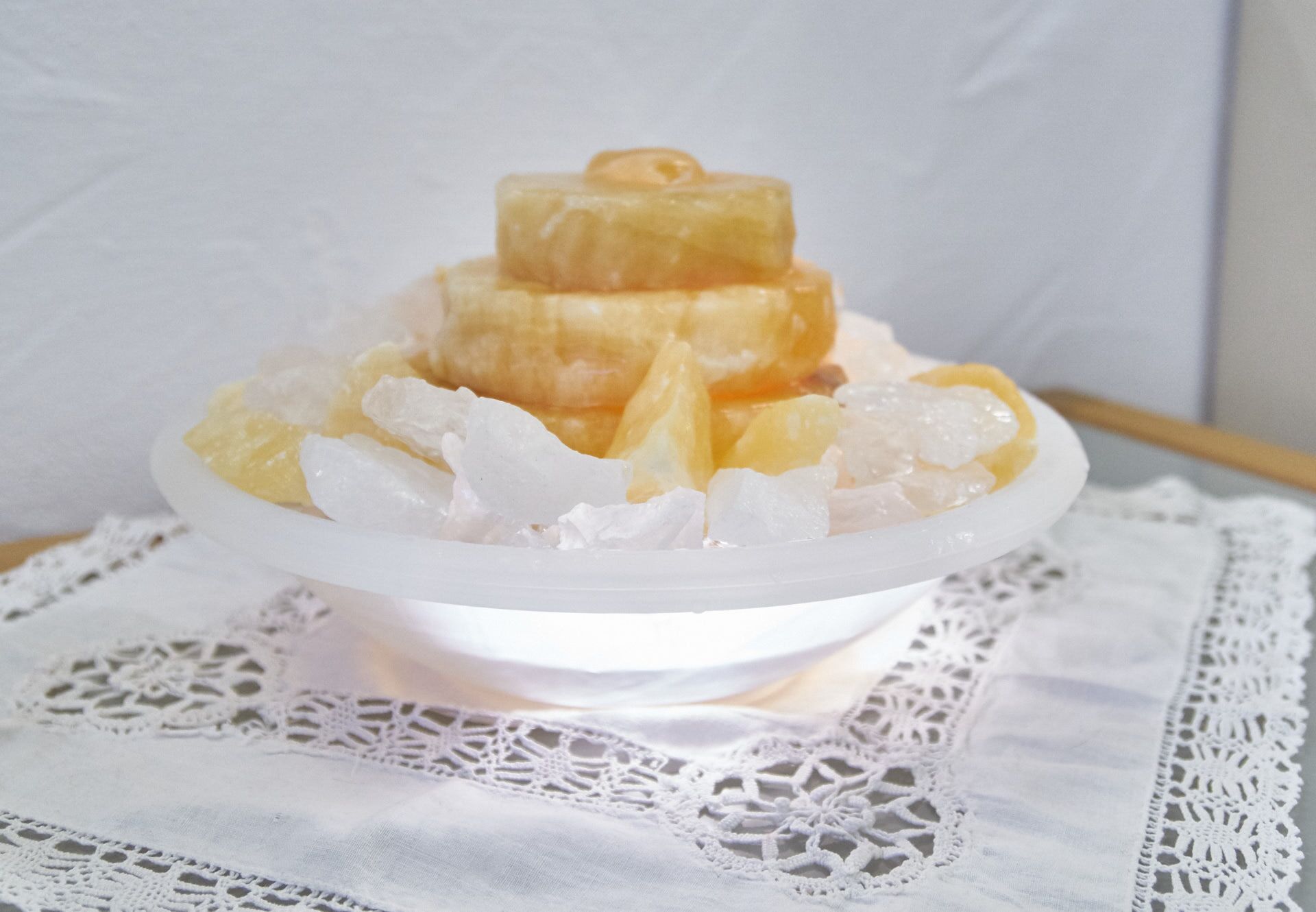 A dessert in a white bowl on a lace doily.