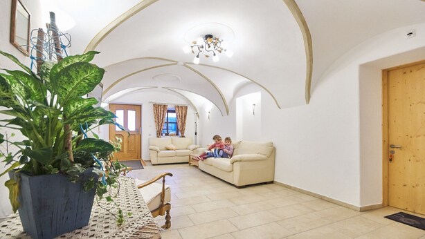A spacious living room with high ceilings and a cozy seating area.