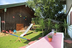 Enjoy a family-friendly atmosphere in our outdoor space with a barn, slide, seesaw, and play equipment.