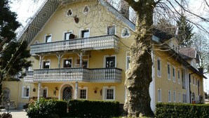 A two-story building with a balcony on the second floor.