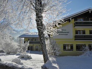 A building with a sign that reads 'Valdhaus Ferienwohnungen' indicating it is a vacation rental.