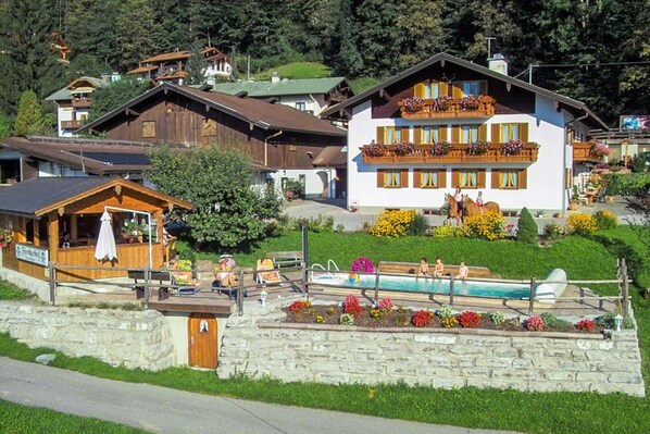 Experience the serene charm of this picturesque village, surrounded by traditional houses and a tranquil pool area.