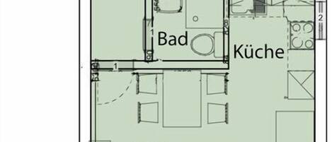 Plano de planta que muestra una sala de estar, cocina, baño, dormitorio y balcón.