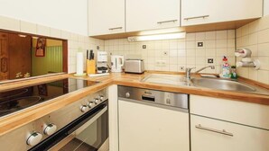 A modern kitchen with a dishwasher, stove, and sink.