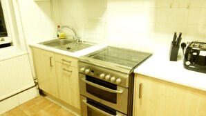 Departamento, 2 habitaciones | Cocina privada | Cafetera y tetera, refrigerador, microondas y horno 