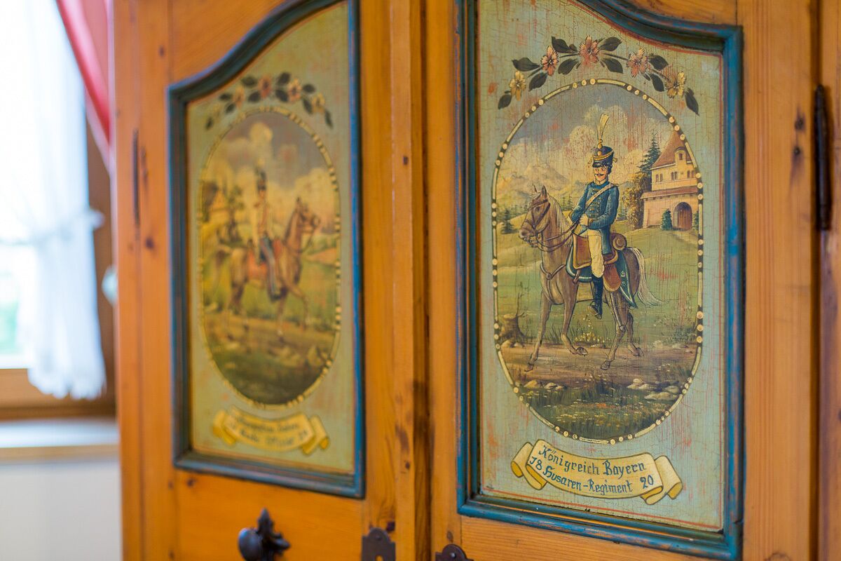 A wooden door with two framed pictures depicting historical military scenes.