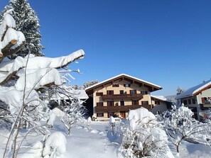Traditional chalet-style building with a central entrance and symmetrical facade.