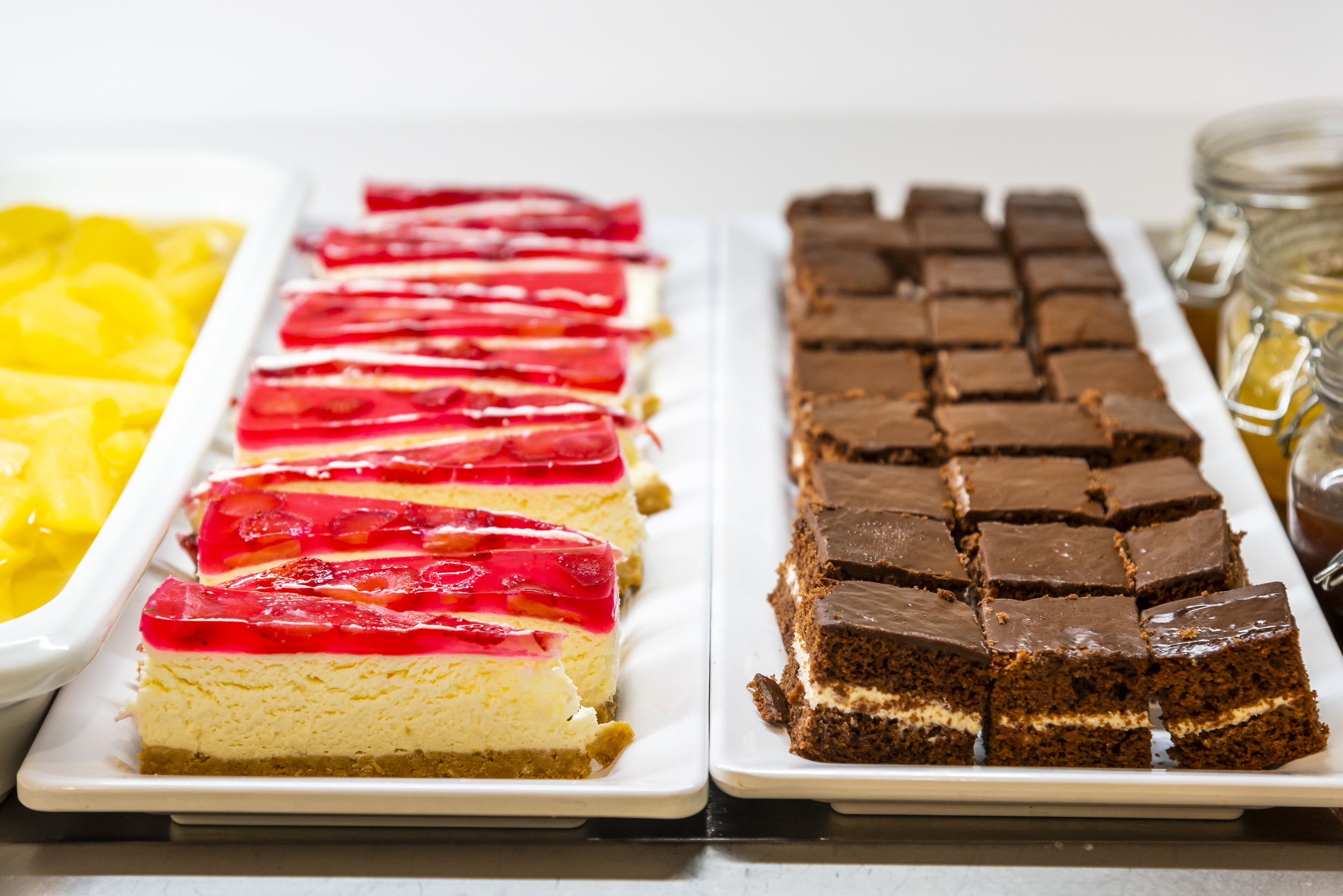 A dessert tray with cheesecake and brownies.