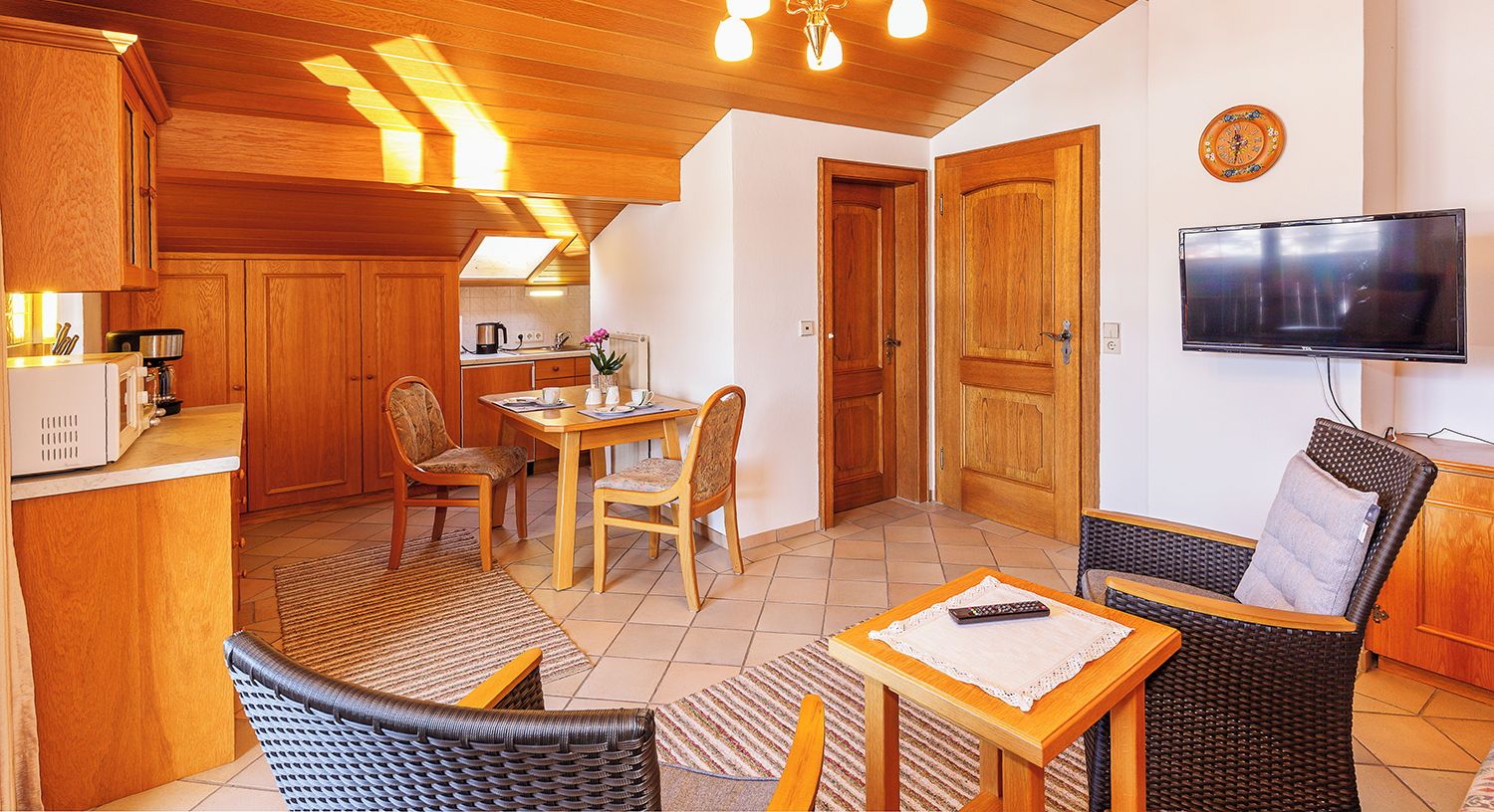 A cozy chalet interior with a dining area, kitchen, and living space.