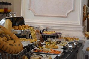 A buffet with various dishes and pastries. - The Guard Hotel (Cairo)