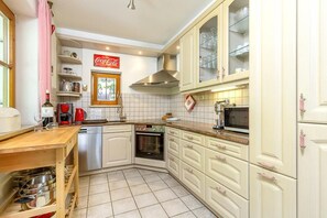 A kitchen with white cabinets, a microwave, a stove, and a dishwasher.