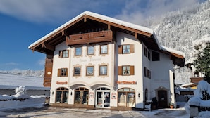 A two-story building with a sign reading "Haus Theresa" and "Parfümerie."