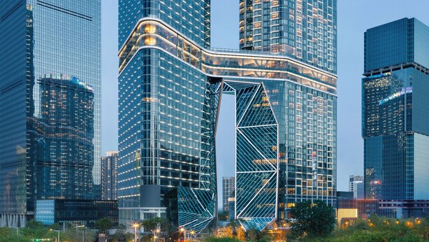 A modern skyscraper with a curved glass facade and a prominent entrance. - Grand Hyatt Xi An (Xi'an)