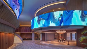 A modern hotel lobby with a large digital art display, a grand chandelier, and a reception desk. - Grand Hyatt Xi An (Xi'an)