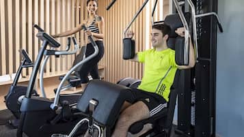 A gym with stationary bikes and a weight machine.