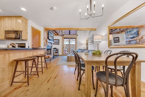 Enjoy meals and relaxation in this open-plan kitchen and dining area, featuring a microwave and stove.
