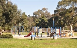 A playground with various play structures and a slide.
