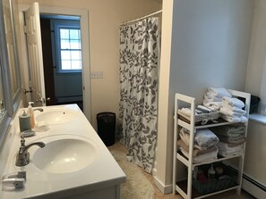 Combined shower/tub, hair dryer, towels, soap