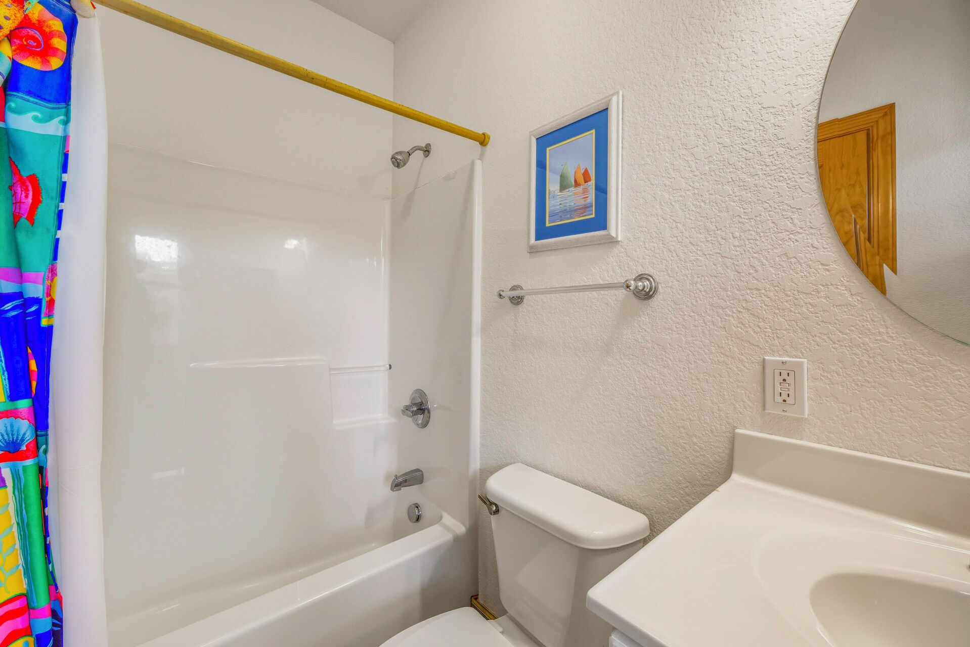 A bathroom with a shower, toilet, and sink.