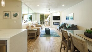 A modern living room with a sofa, coffee table, and TV. - Stunning Ocean, Pool, and Garden views from Beautifully Appointed Unit! (Oceanside)