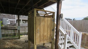 A wooden playhouse with a white staircase and a sign that says "CLOSE DOOR TO KEEP PETS OUT". - LastMinuteSpecial/OceanFront/Pool/HotTub/XBOXoneS/ping pong table (Nags Head)