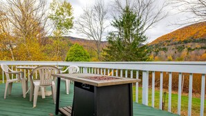 A deck with a table and chairs, overlooking a hillside with autumn foliage. - Check our Reviews! Spectacular Views! King bed! Upgraded Baths n Kitchen! (Hunter)