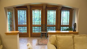 A room with a wooden bench, a small chair, and a dog. - Beautiful home in private setting yet only15 min to town  & 10 min to lake (Durango)