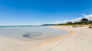 A beach with clear water, sandy shore, and distant hills. - SALTWATER POOLSIDE -8m Heated* Pool, an entertainers delight -BONUS*NIGHTS 2026 (rye)