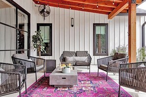 A cozy living area with a sofa, chairs, a coffee table, and a patterned rug. - Pet Friendly! WalkerVR The Owners House *Texas Oasis* Pool and Hot Tub (Austin)