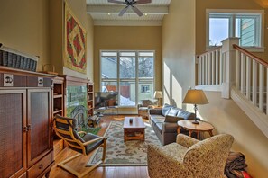 Cozy living room with a fireplace, sofa, chairs, and a television.