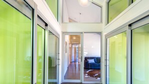 A modern hallway with glass doors leading to a living area. - Nine Steps - private estate on 29 acres with stunning views of Mount Buffalo (Porepunkah)