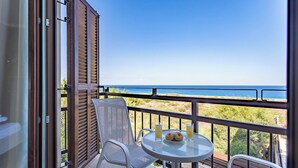 A balcony with a table, chairs, and a view of the sea. - Four Bedroom Front Line (Sea-Front) villa located in an excellent location in the area of Cape Greco (Protaras)
