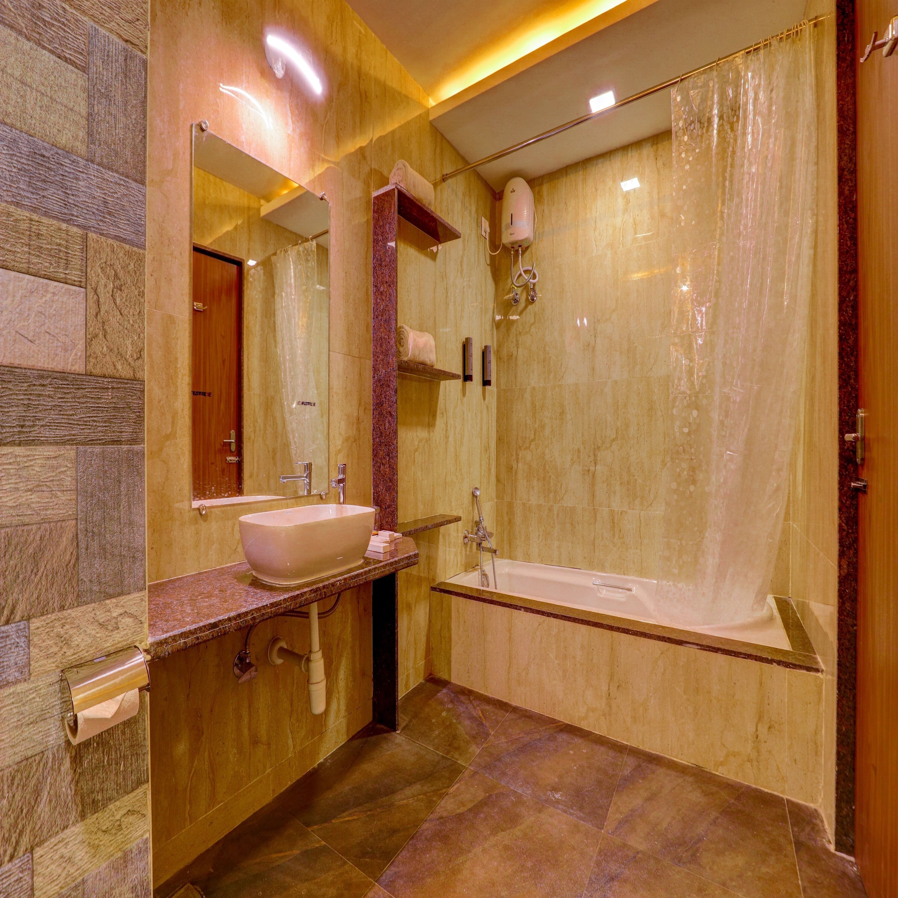 A modern bathroom with a marble vanity, a large mirror, a bathtub, and a shower curtain.