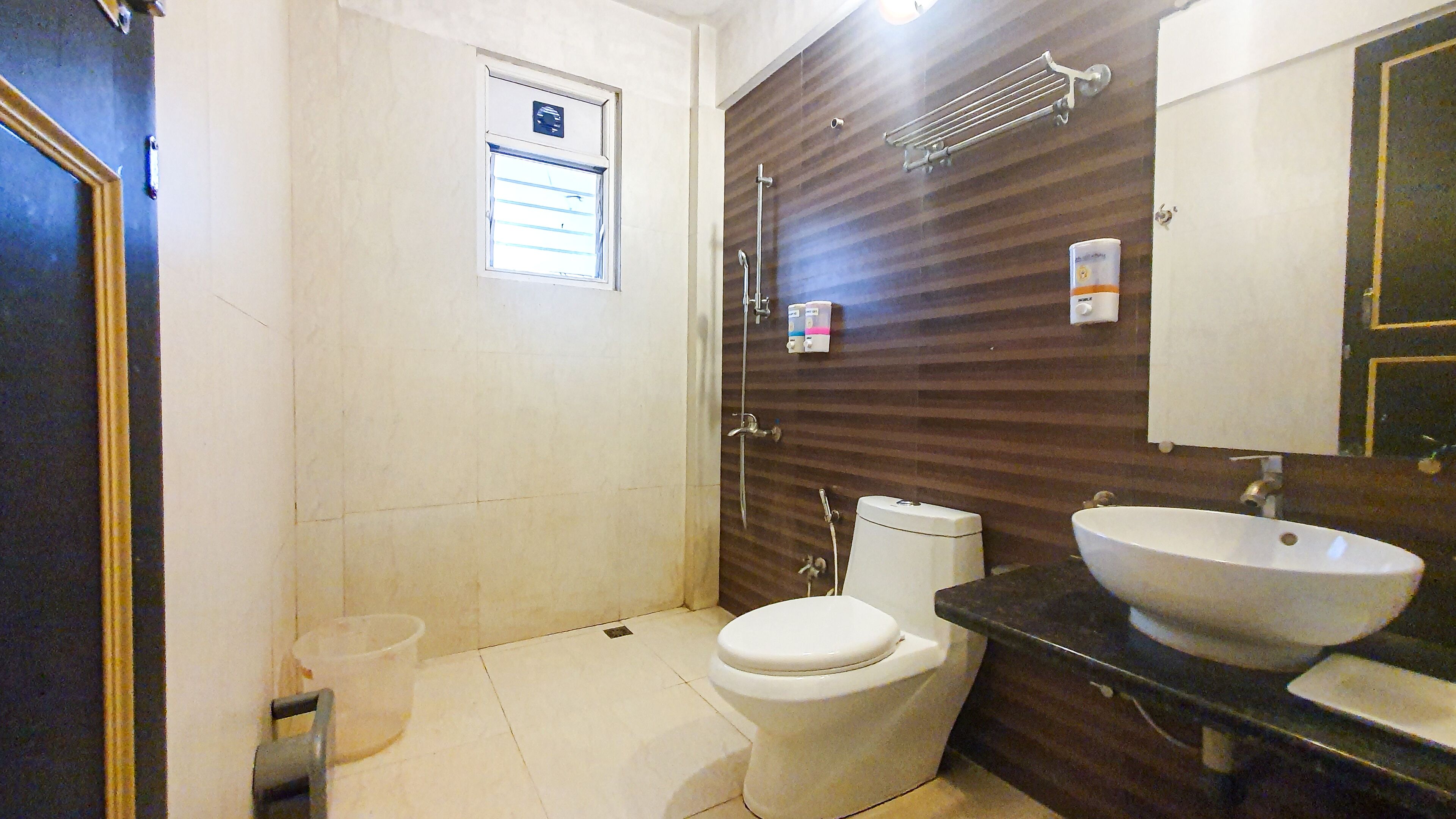 A bathroom with a toilet, sink, and shower.