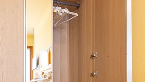 A walk-in closet with open shelves, a hanging rack, and a black storage unit. - B&B DA NINA VENEZIA  (Venice)