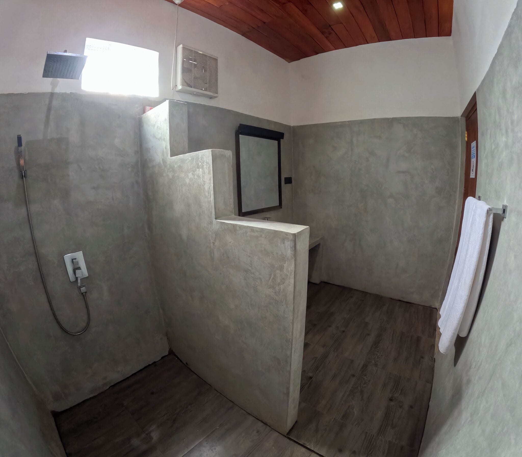 A bathroom with a shower, a sink, and a mirror.