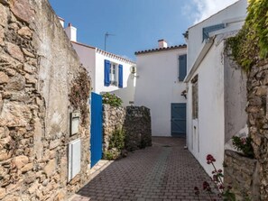 Stroll through a charming, cobblestone alleyway lined with traditional buildings.