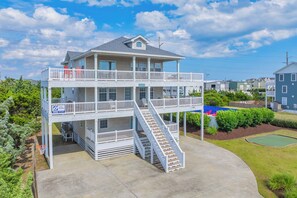 A two-story building with a balcony and a staircase leading to the upper level.