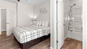 A bedroom with a bed, a ceiling fan, a wall-mounted light, and a shower area. - PERFECT GETAWAY Home Private POOL+SPA Poker+Pool Table, GREAT LOCATION! (North Myrtle Beach)