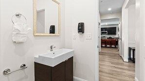 A modern bathroom with a white sink, dark wooden vanity, a mirror, and a towel rack. - PERFECT GETAWAY Home Private POOL+SPA Poker+Pool Table, GREAT LOCATION! (North Myrtle Beach)