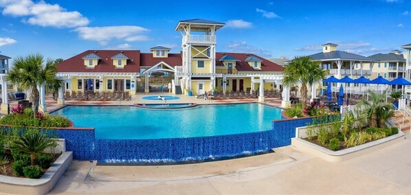 A hotel with a large pool, a lifeguard tower, and multiple balconies. - La Sea-Esta - Book 5+nights get 15% discount- 3BD/2BA. Sleeps 8 (Galveston)