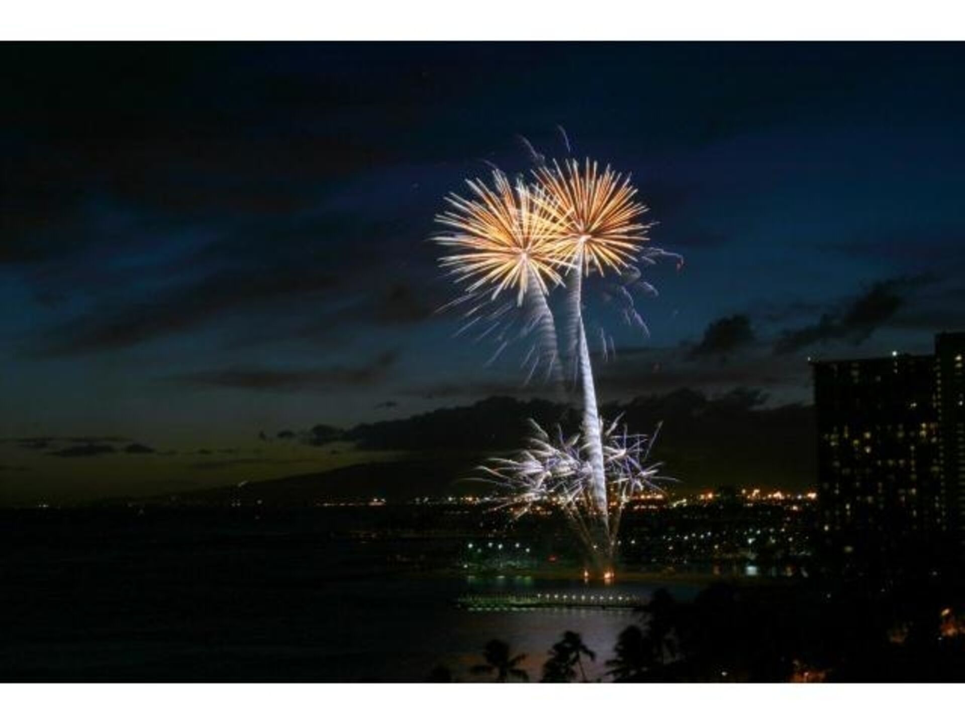 A nighttime cityscape with a prominent display of fireworks.