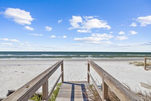 A wooden boardwalk leading to a beach with a clear view of the ocean. - Happy Hours- 5 BR Home on N. Cape- Beachfront, Pet Friendly, Sleeps 16 (Cape San Blas)