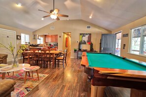 A spacious living room with a pool table, dining area, and kitchen. - Secluded Cabin with ALL the amenities (Wimberley)