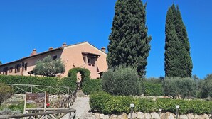 A building with a sloped roof and a wooden staircase leading to a door. - 2 bedrooms, large pool, stunning views of San Gimignano, Tuscany, private garden (San Gimignano, Tuscany)
