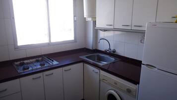Fridge, microwave, coffee/tea maker, cookware/dishes/utensils
