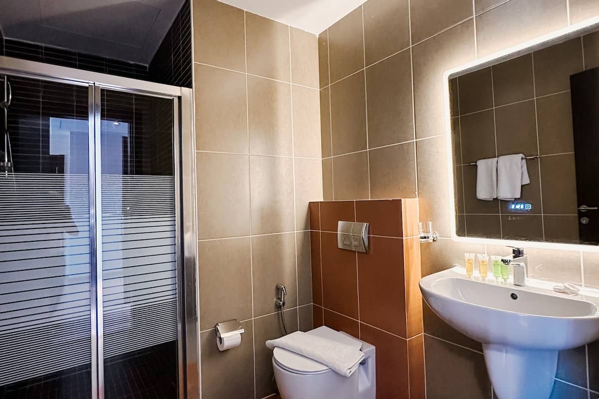 separate bathtub and shower, slippers, towels, soap