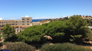 A coastal building with a dome and arched windows, surrounded by greenery and overlooking the sea. - Modern, quietly located vacation apartment with sea view + close to the beach, fully air-conditioned (Carvoeiro (Vale Centeanes))